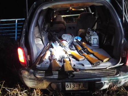 Three arrested with a stolen SUV, cash, and a trunk full of guns