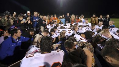 Photo of Jasper County Coach in trouble for leading team prayer.