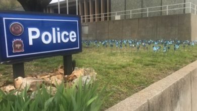 Photo of JPD officers set out blue pinwheels for National Child Abuse Month