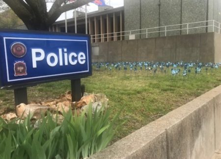 JPD officers set out blue pinwheels for National Child Abuse Month