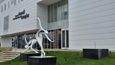 Photo of Repairs being made to sculpture outside the Cornell Center