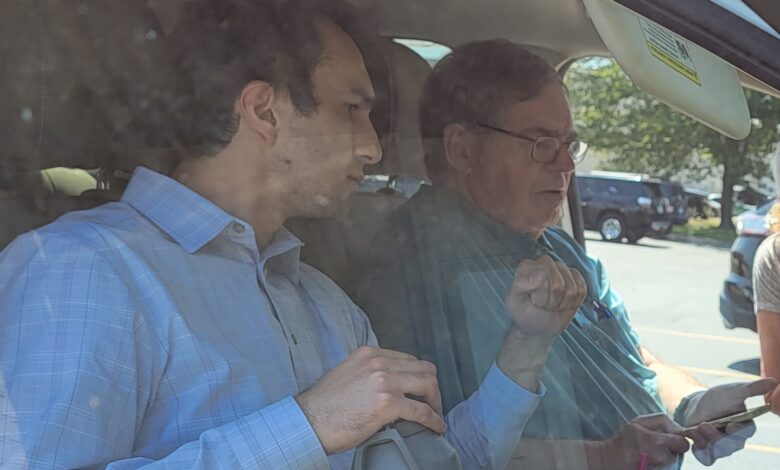 Steve Scott and Ted Bojorquez help a Joplin citizen pair their Bluetooth device to their vehicle