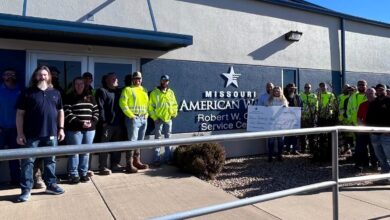 Photo of Missouri American Water employees present check to Christmas of Hope